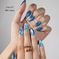 Thumbnail for Hand with blue nail polish wearing a gold ring on a neutral background