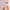 Person wearing a mild collagen face mask with text about skincare benefits of the Hoygi mild collagen skin mask a light gray background. 
