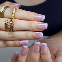 Thumbnail for Close-up of hands with pink nail polish and gold rings on a neutral background