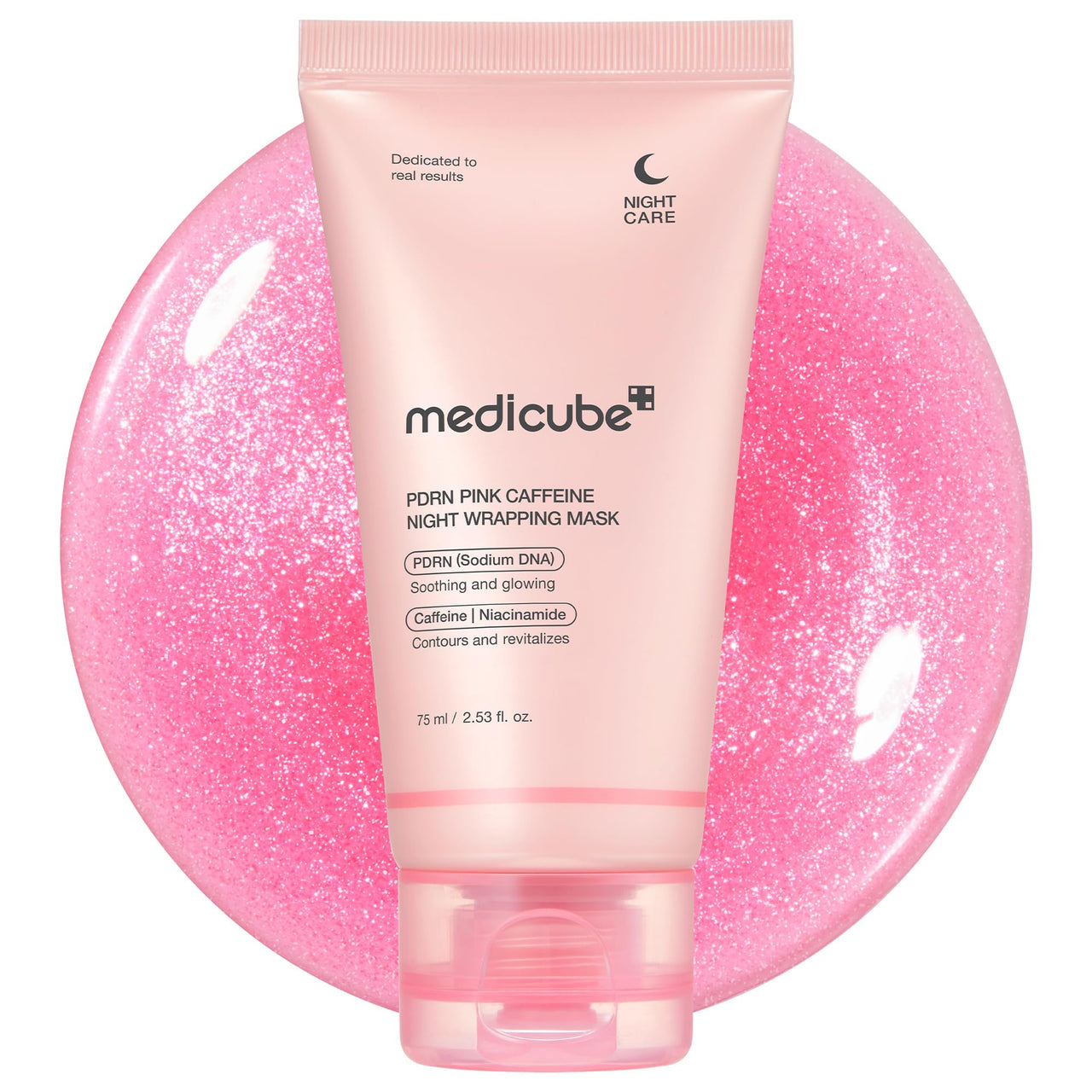 Pink tube of Medicube PDRN Pink Caffeine Night Wrapping Mask on a pink glittery background